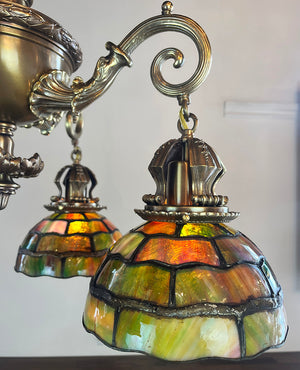 Incredible Early 1900s Beaux Arts Four Light Cast Bronze and Brass Dolphin Arm Chandelier with Original Leaded Glass Shades