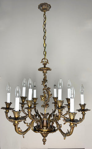 Antique Circa 1920 Ten Light European Bronze Rococo Revival Chandelier with Cast Figural Cherub