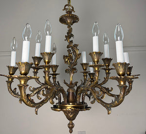 Antique Circa 1920 Ten Light European Bronze Rococo Revival Chandelier with Cast Figural Cherub