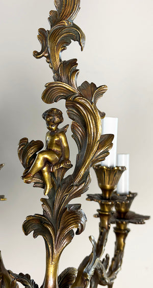 Antique Circa 1920 Ten Light European Bronze Rococo Revival Chandelier with Cast Figural Cherub