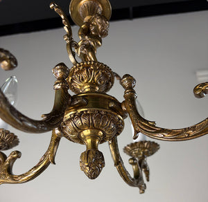 Antique Circa 1940 Cast Brass Petite Four Light Chandelier with a Cast Cherub